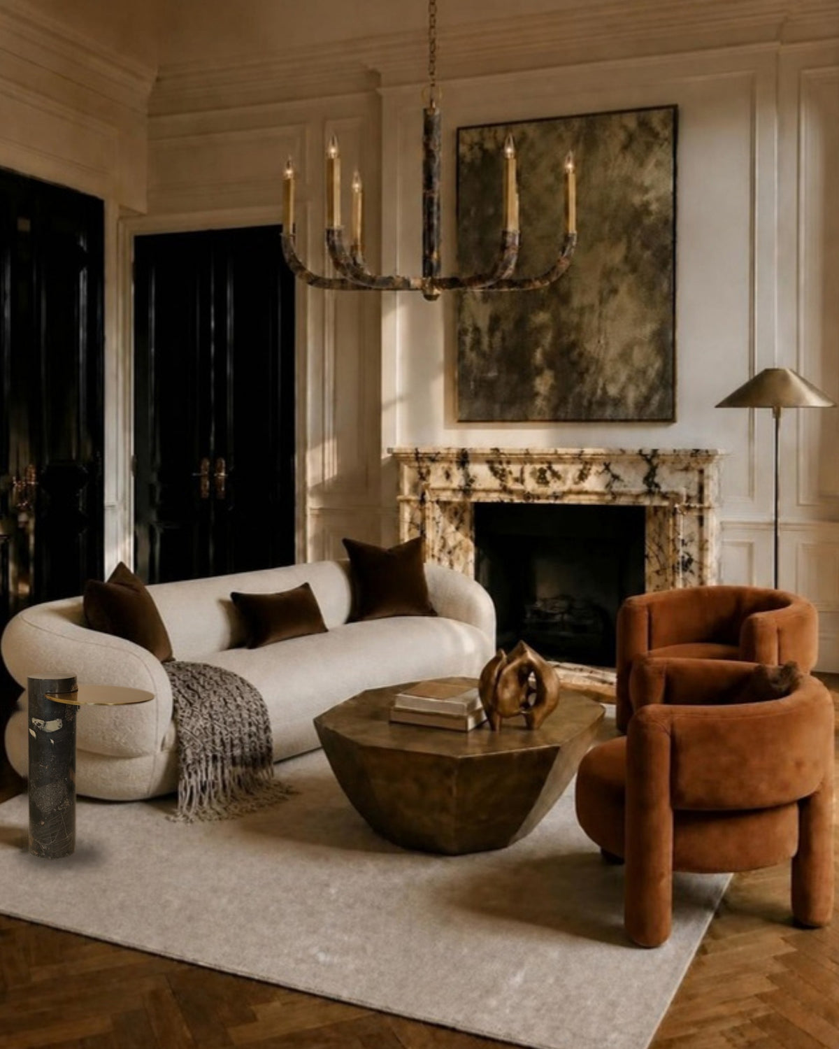 Luxe Legacy living room designed by Rachel Blindauer: curved ivory sofa, marble and brass drink table, bronze coffee table, rust barrel chairs and bronze sculpture