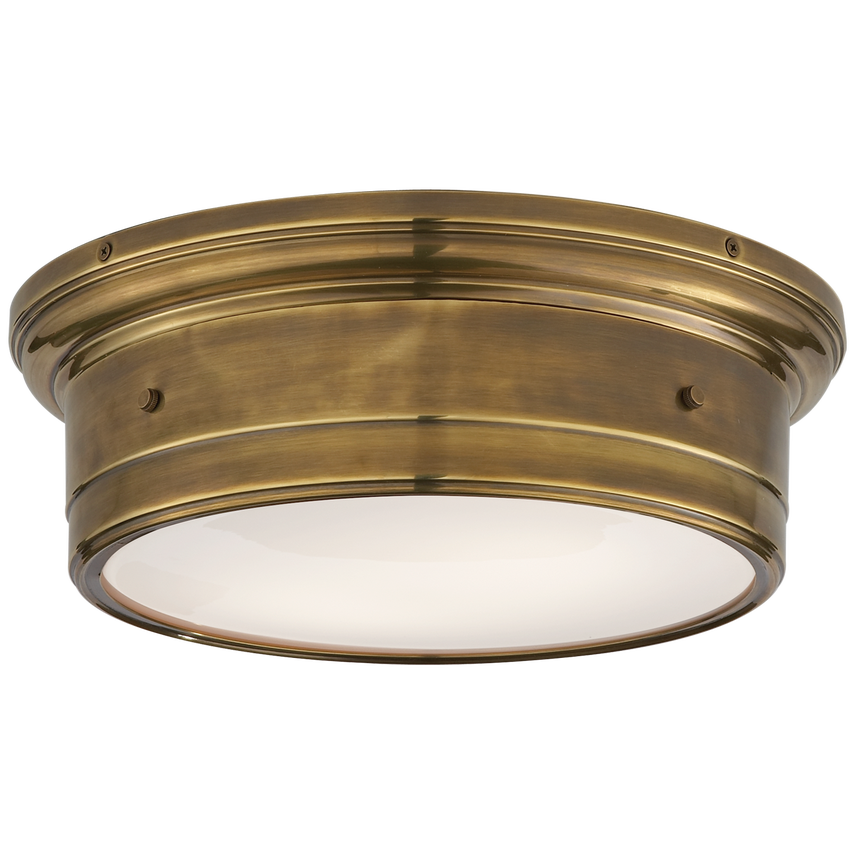 Low-profile flush mount with white glass diffuser and brass frame, casting a soft glow with sculptural elegance for ceilings under 9 feet.
