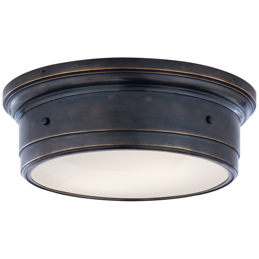 Low-profile flush mount with white glass diffuser and brass frame, casting a soft glow with sculptural elegance for ceilings under 9 feet.