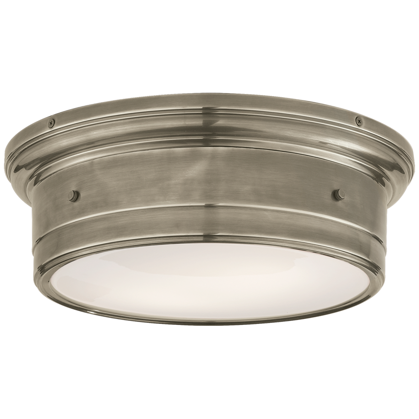Low-profile flush mount with white glass diffuser and brass frame, casting a soft glow with sculptural elegance for ceilings under 9 feet.