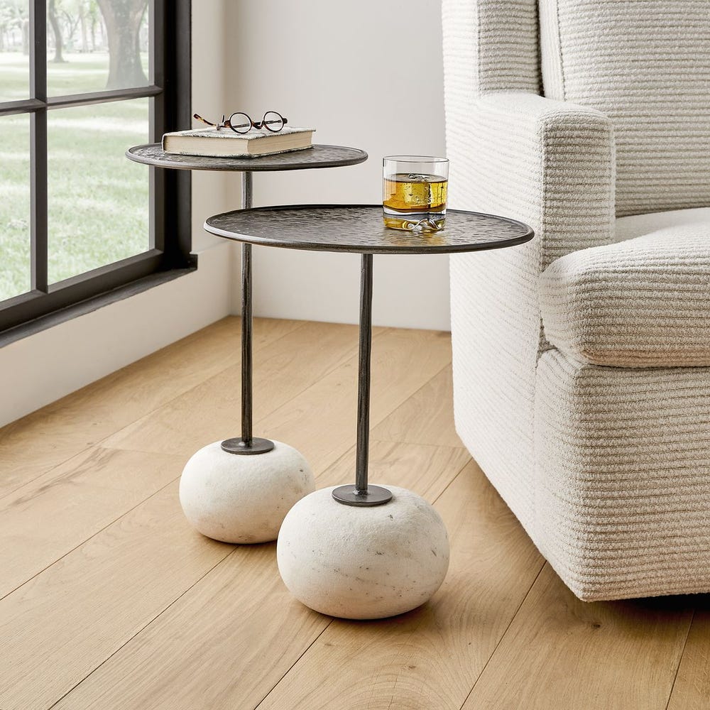 Sculptural accent table with weathered metal top and stone base – Rachel Blindauer