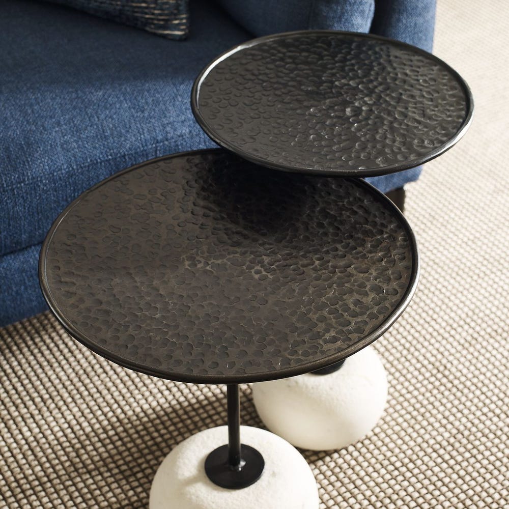Sculptural accent table with weathered metal top and stone base – Rachel Blindauer