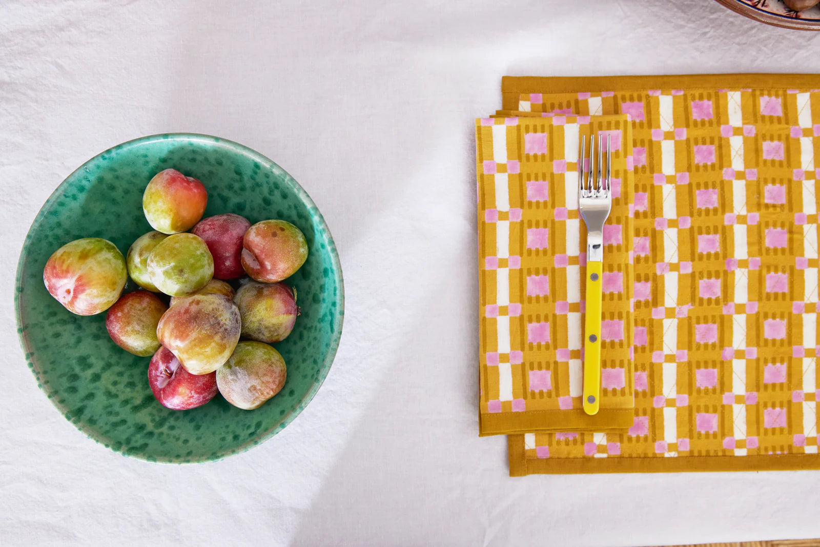 Hand block printed plaid napkin in terracotta, blush, and sand on linen-cotton blend