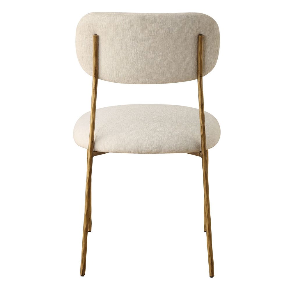 Sculptural iron dining chair with antique gold finish and floating off-white upholstered backrest.