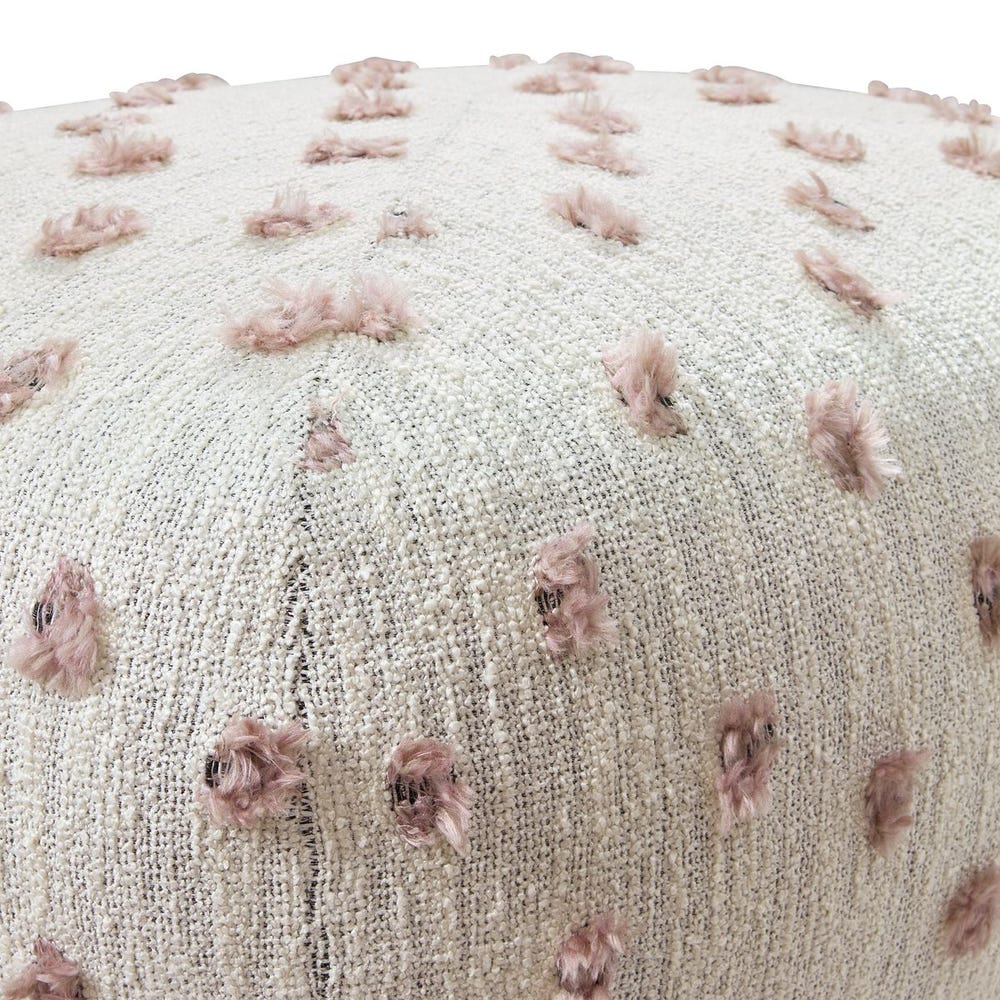 Round textured ottoman with pink floral patterns on a white background