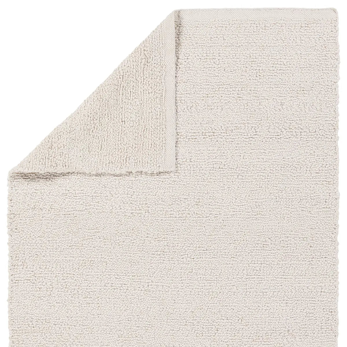 White handwoven rug with a raised bouclé rug texture, crafted from durable 100% PET yarn for indoor and outdoor use, designed for serene, coastal-inspired interiors.