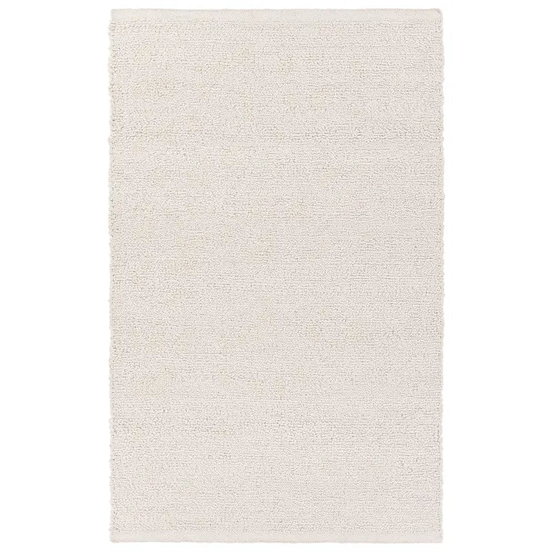 White handwoven rug with a raised bouclé rug texture, crafted from durable 100% PET yarn for indoor and outdoor use, designed for serene, coastal-inspired interiors.