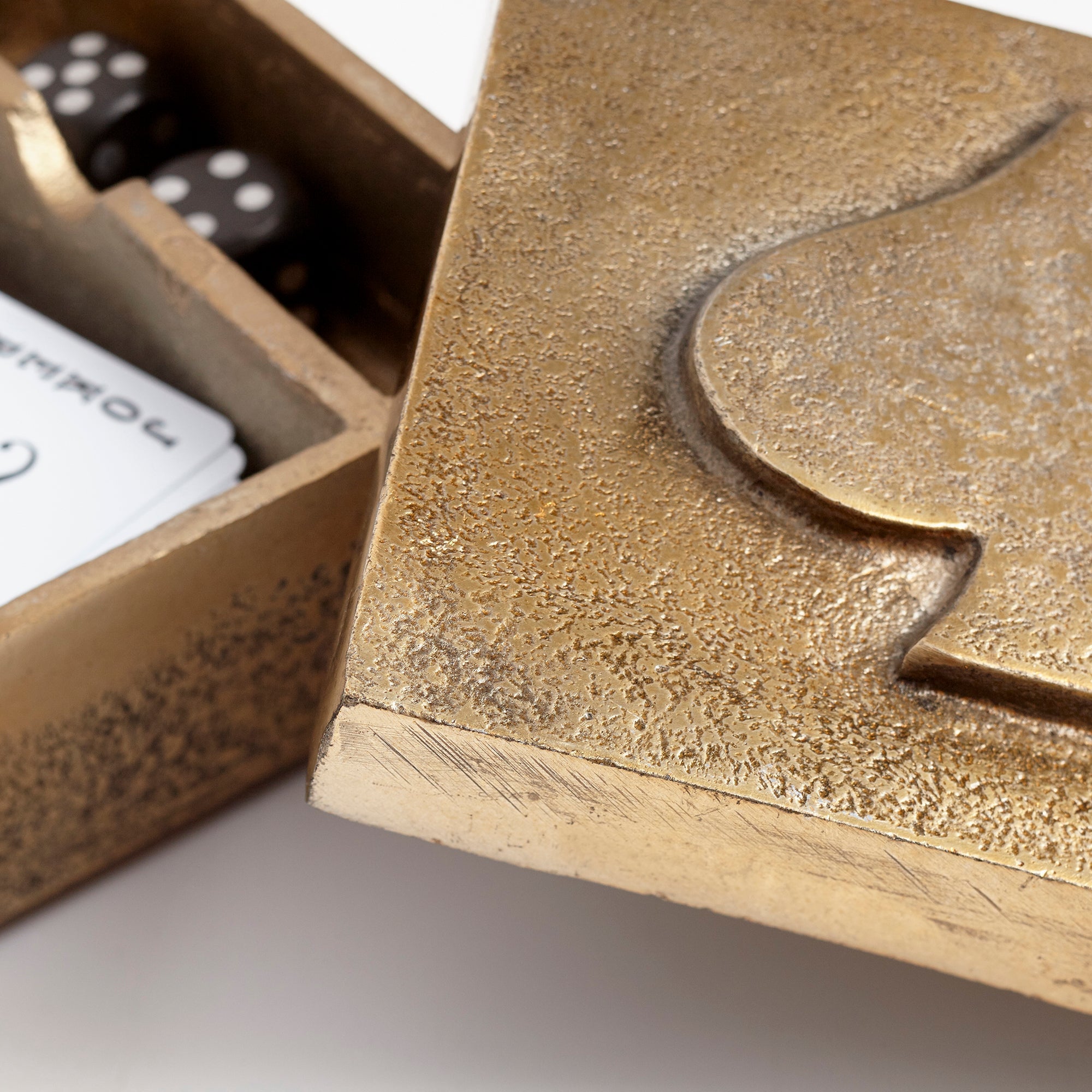 Close-up of a decorative gold box with spade card symbol