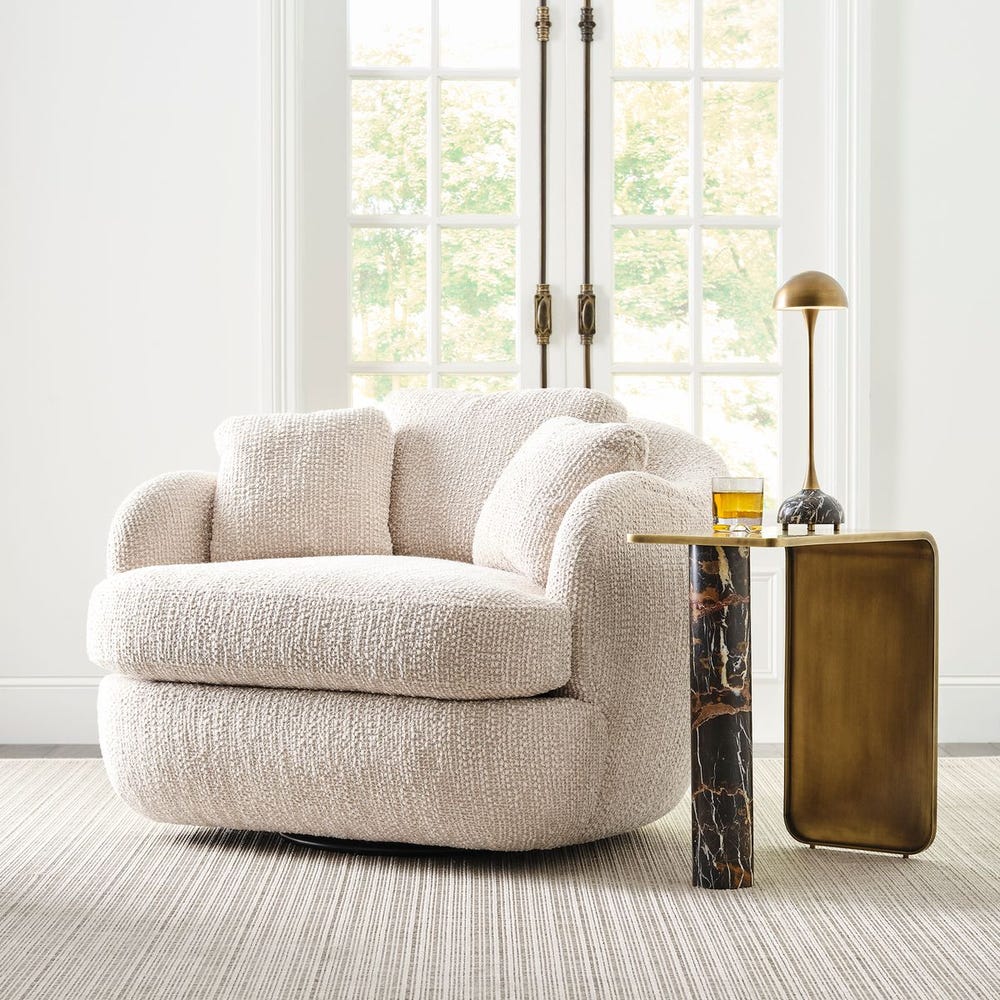 Modern swivel lounge chair upholstered in soft chenille with wide seat, scooped arms, and a rounded silhouette, styled for cozy, quiet luxury.