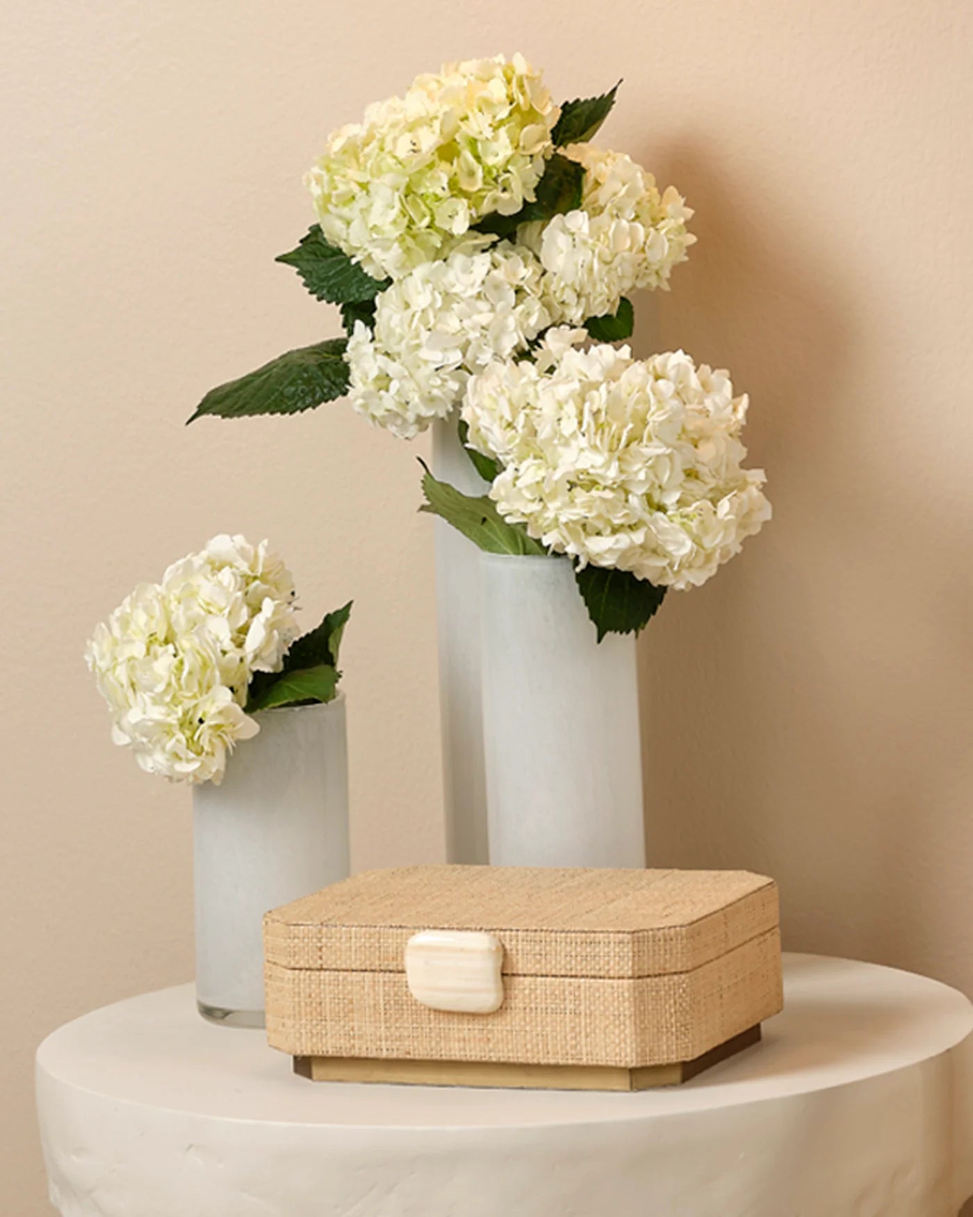 Handwoven raffia box with ox bone trim and ultrasuede-lined interior for elegant storage