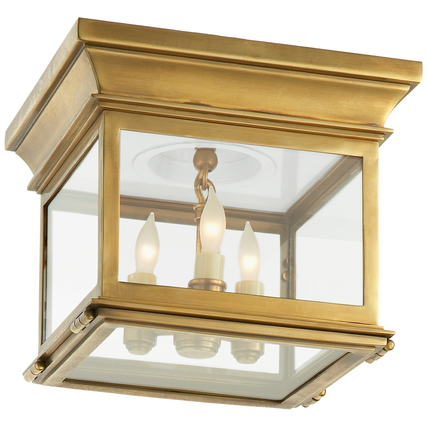Hudson Small Square Flush Mount light with burnished brass frame and clear glass panels, shown ceiling-mounted in a hallway.