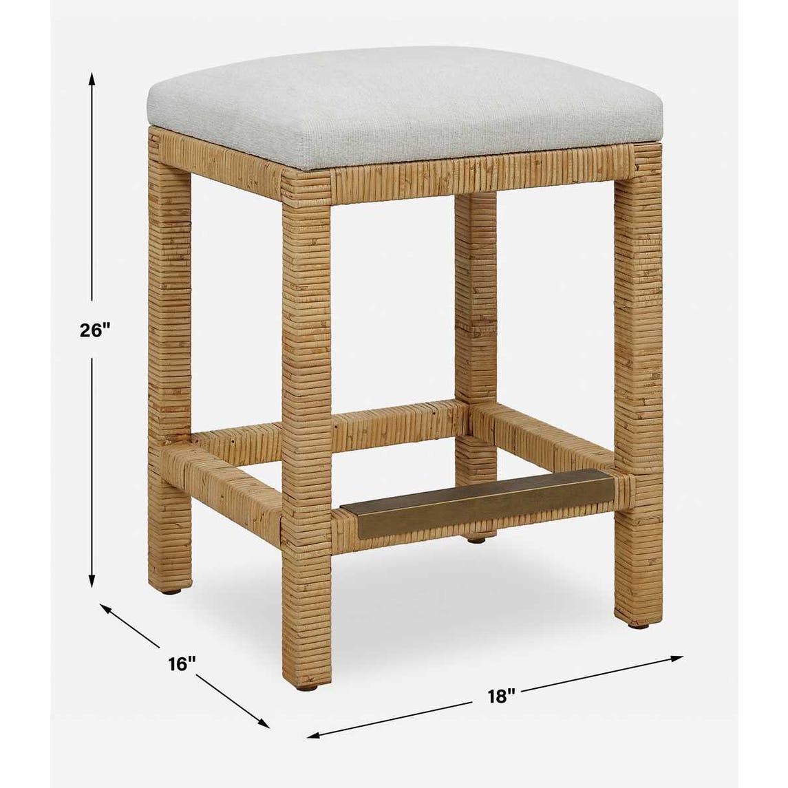 Handwoven rattan counter-height stool with off-white cushion and antique gold kickplate—coastal-inspired and refined.