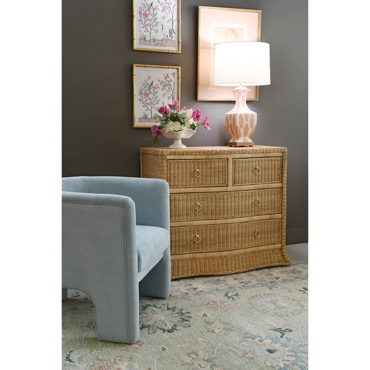 Woven rattan chest with four drawers, light wood frame, and satin brass pulls, ideal for bedroom, entryway, or coastal-inspired interiors.