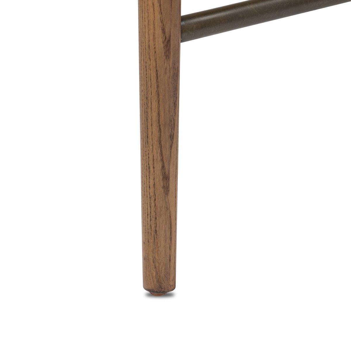 Close-up of a wooden chair leg on a white background