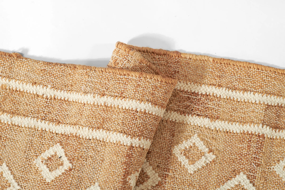 Marigold Handwoven Blockprint Flatweave Rug — close-up of rolled edge showing handwoven jute texture and border stripe detail, one of Rachel Blindauer's favorites