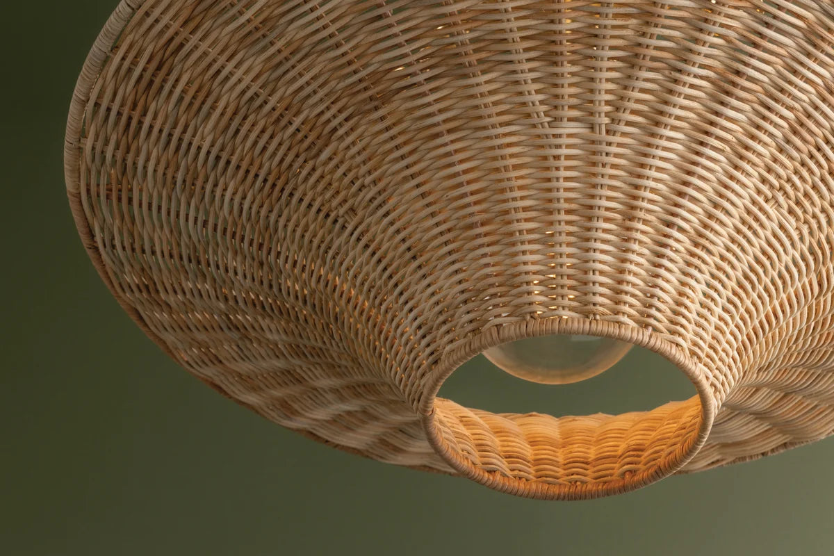 Handwoven wicker ceiling light with flared silhouette and gold canopy—coastal modern style with upward and downward ambient glow.