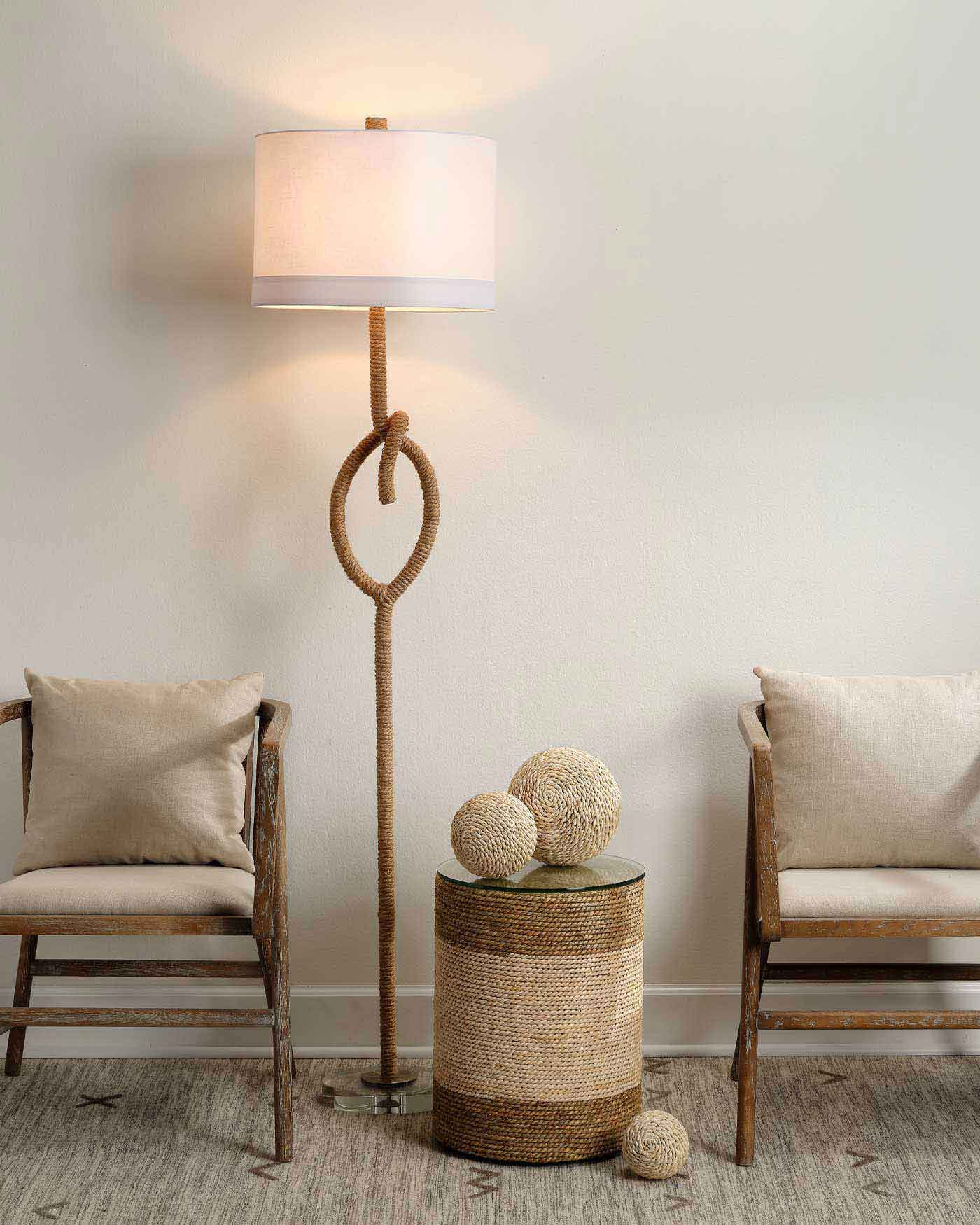 Tall rope-wrapped floor lamp with sculptural knot, clear acrylic base, and white linen shade—perfect for coastal-inspired interiors.