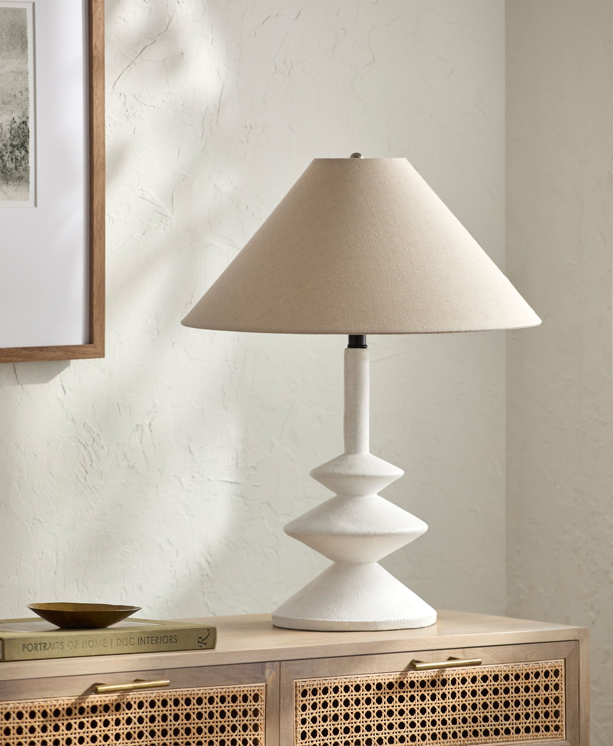 Antiqued table lamp with slender tapered silhouette and white cotton drum shade