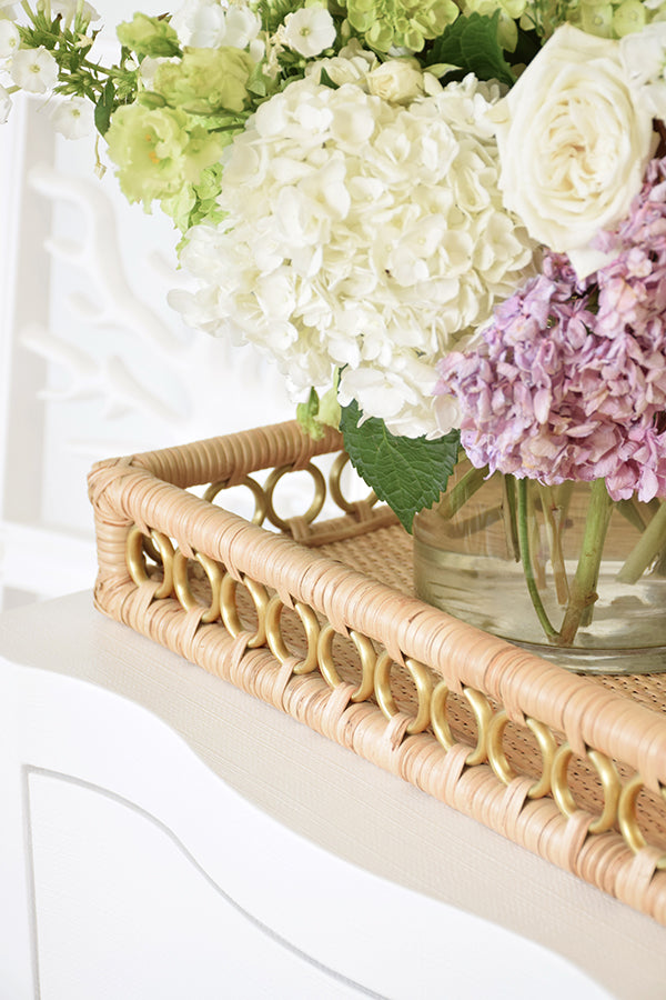 Rectangular rattan catchall tray with brass ring handles—ideal for styling coffee tables, organizing entryways, or serving drinks.