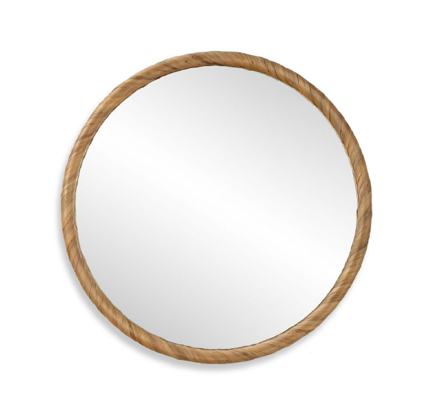 Round 32-inch wall mirror framed in hand-wrapped natural seagrass with tonal variations. Can be styled above a linen bench in a coastal modern entryway.