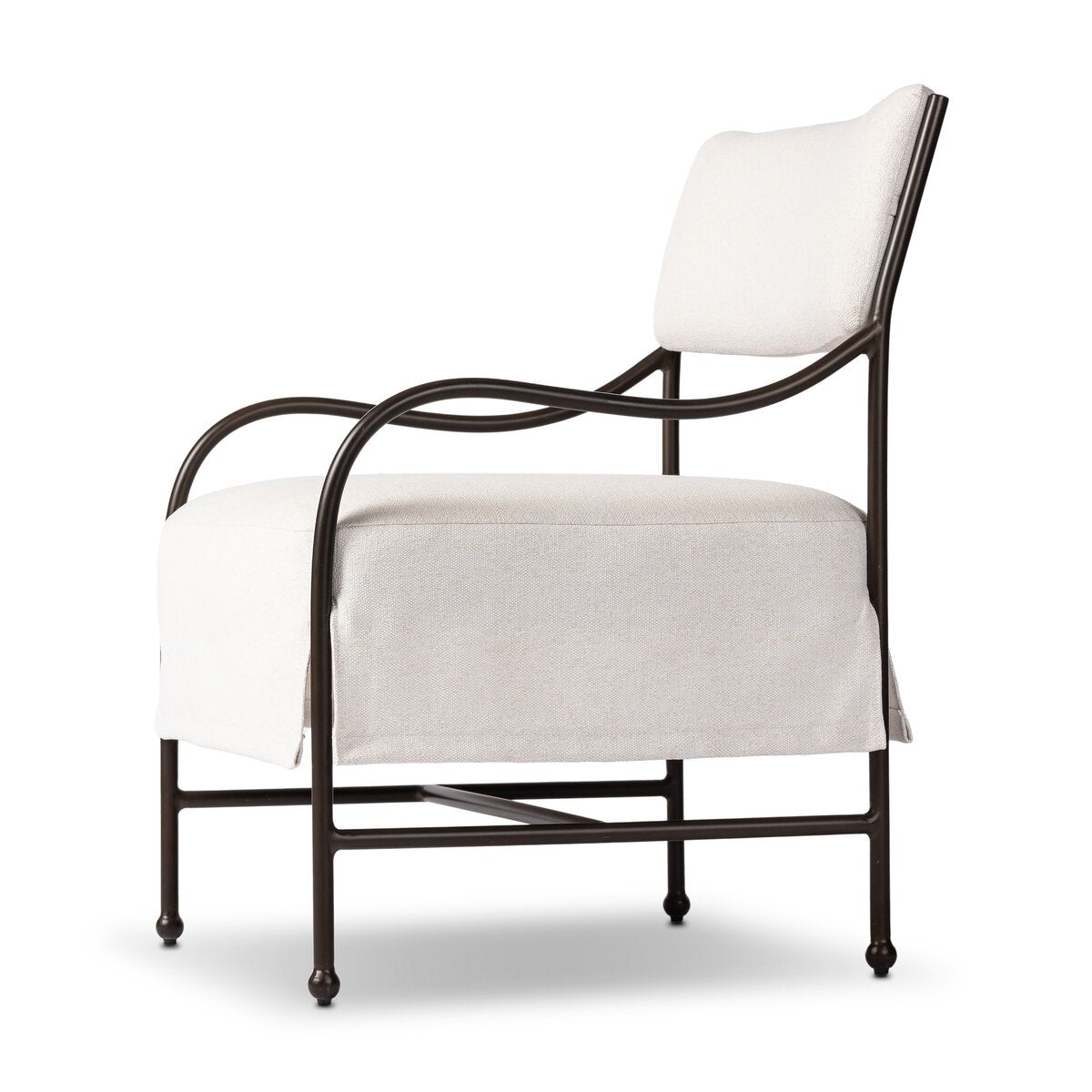 Outdoor lounge chair with curved matte gunmetal frame and handwoven linen-toned seat, styled for sculptural coastal living.