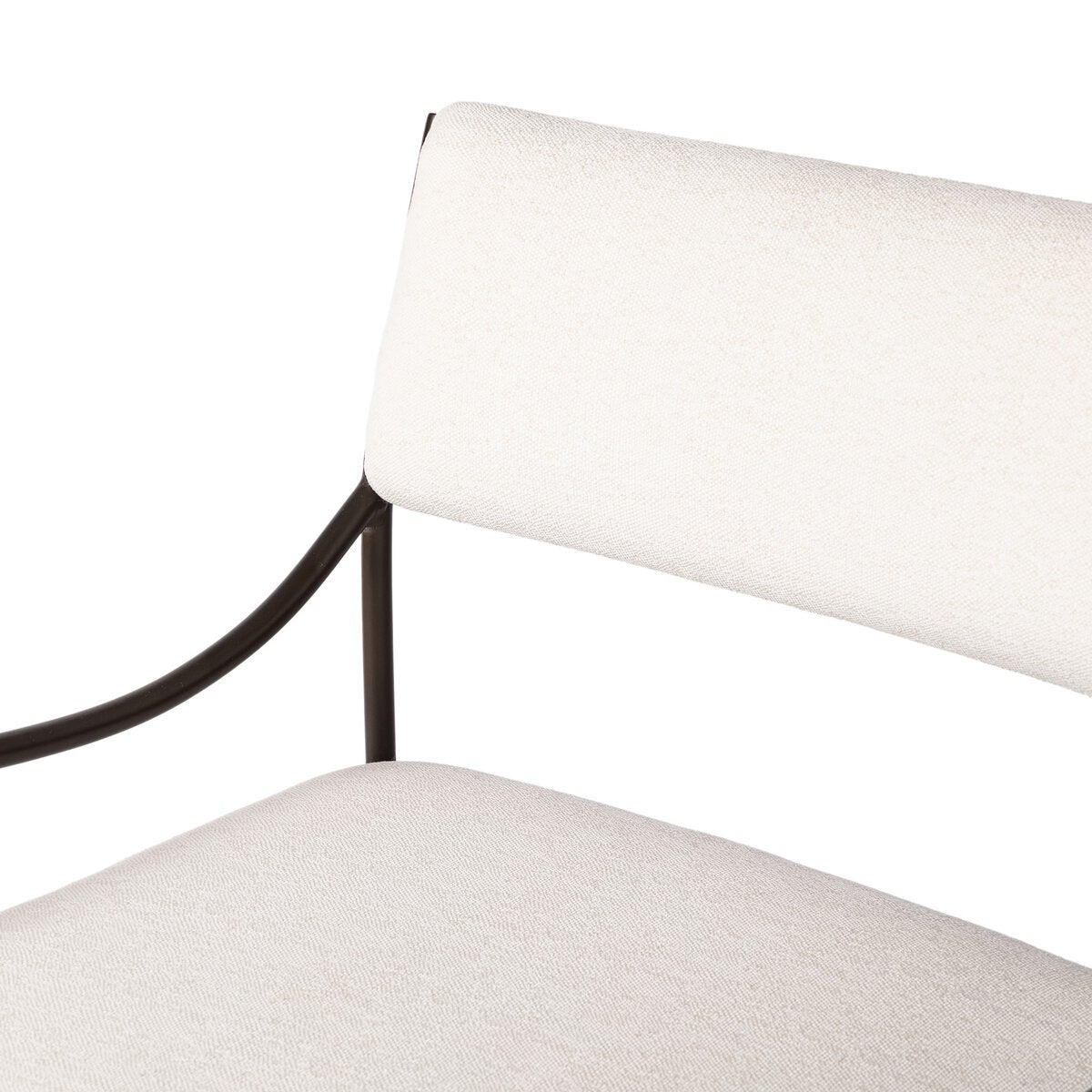 Outdoor lounge chair with curved matte gunmetal frame and handwoven linen-toned seat, styled for sculptural coastal living.