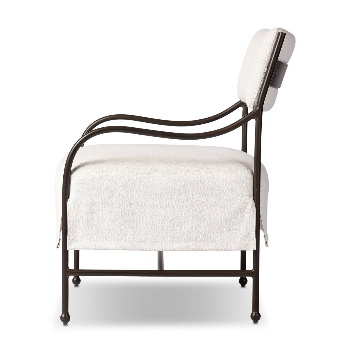 Outdoor lounge chair with curved matte gunmetal frame and handwoven linen-toned seat, styled for sculptural coastal living.