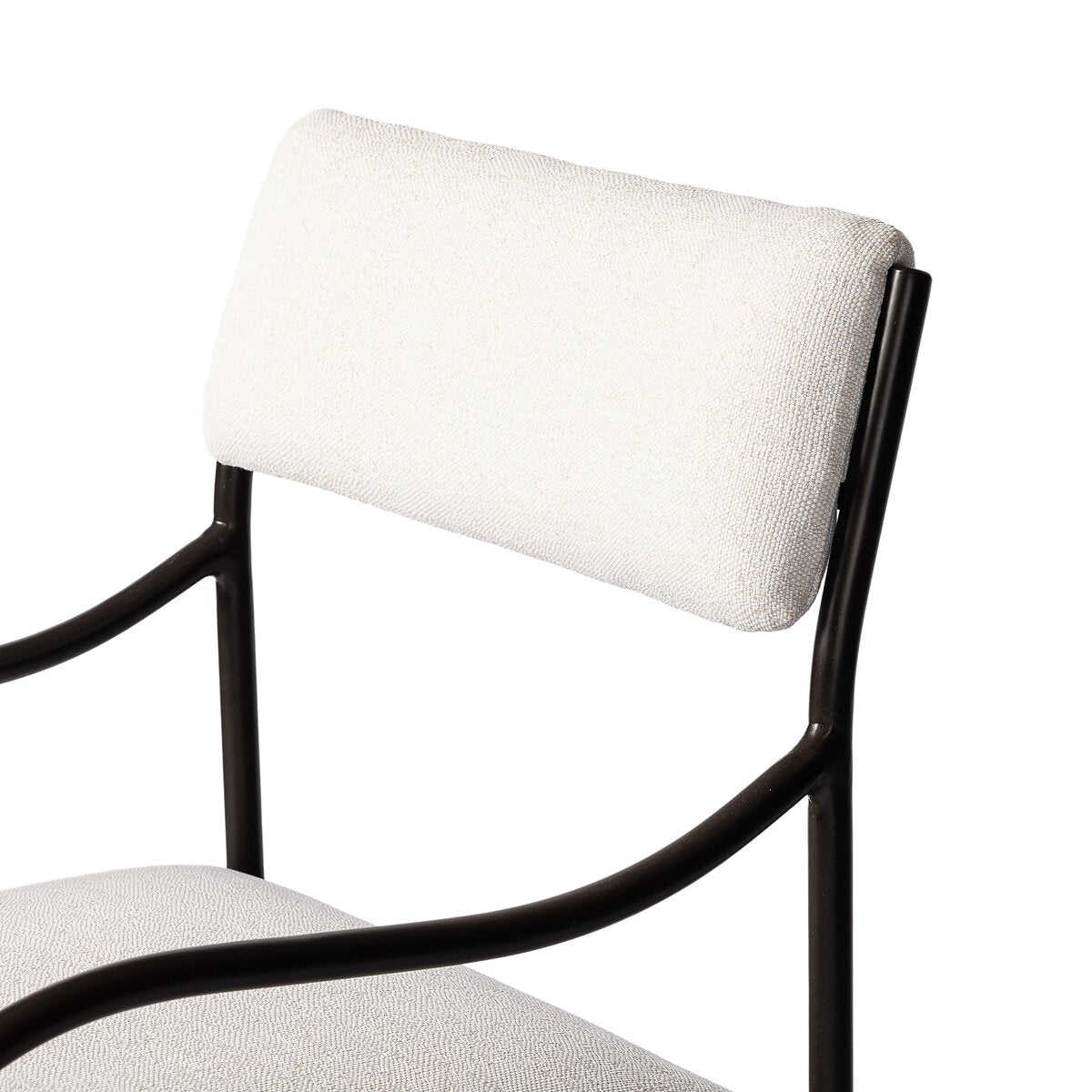 Sculptural outdoor dining chair with curved matte gunmetal frame and linen-toned all-weather weave, styled for refined alfresco dining.