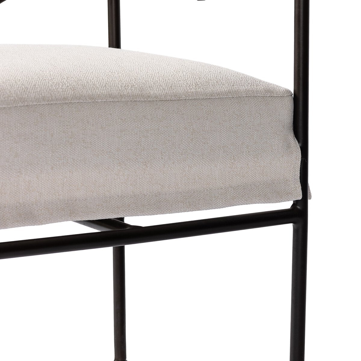 Sculptural outdoor dining chair with curved matte gunmetal frame and linen-toned all-weather weave, styled for refined alfresco dining.