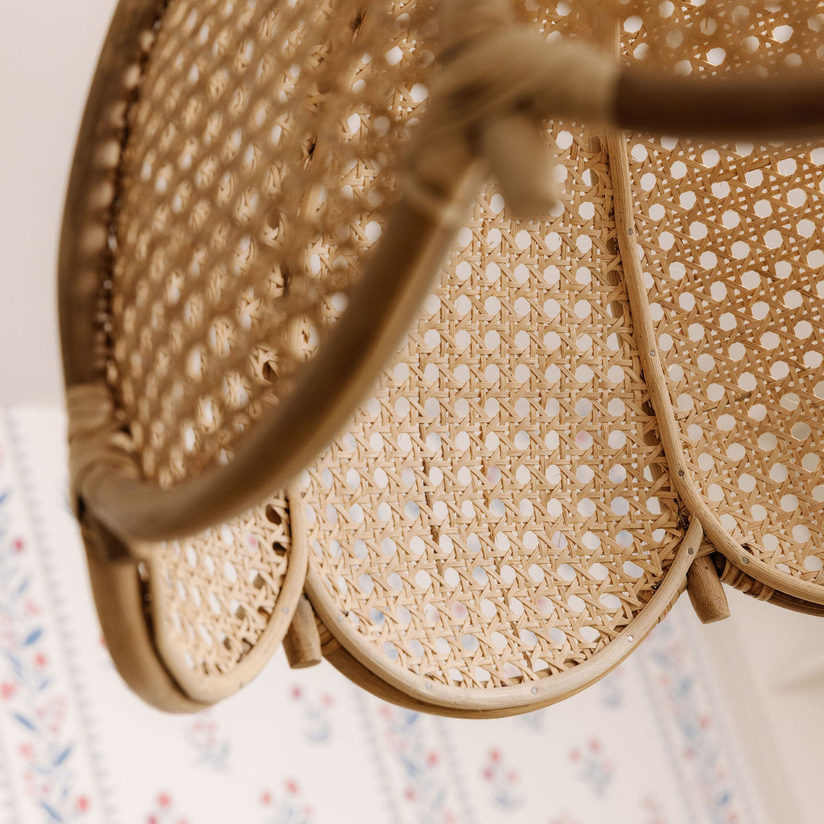 Close-up of the open-weave cane panels and scalloped edge