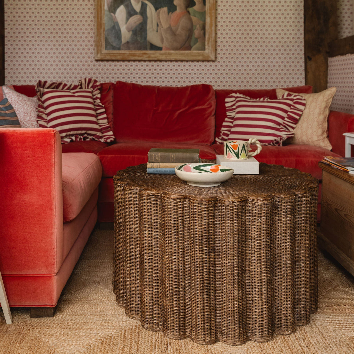 Fluted teak rattan coffee table in a living room with a red sofa