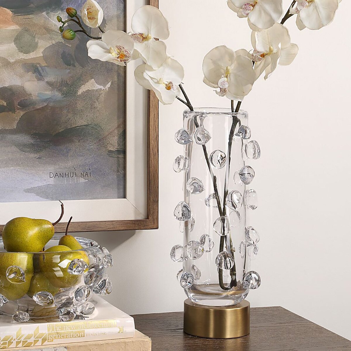 Crystal Droplet glass vase holding white orchid stems on a console