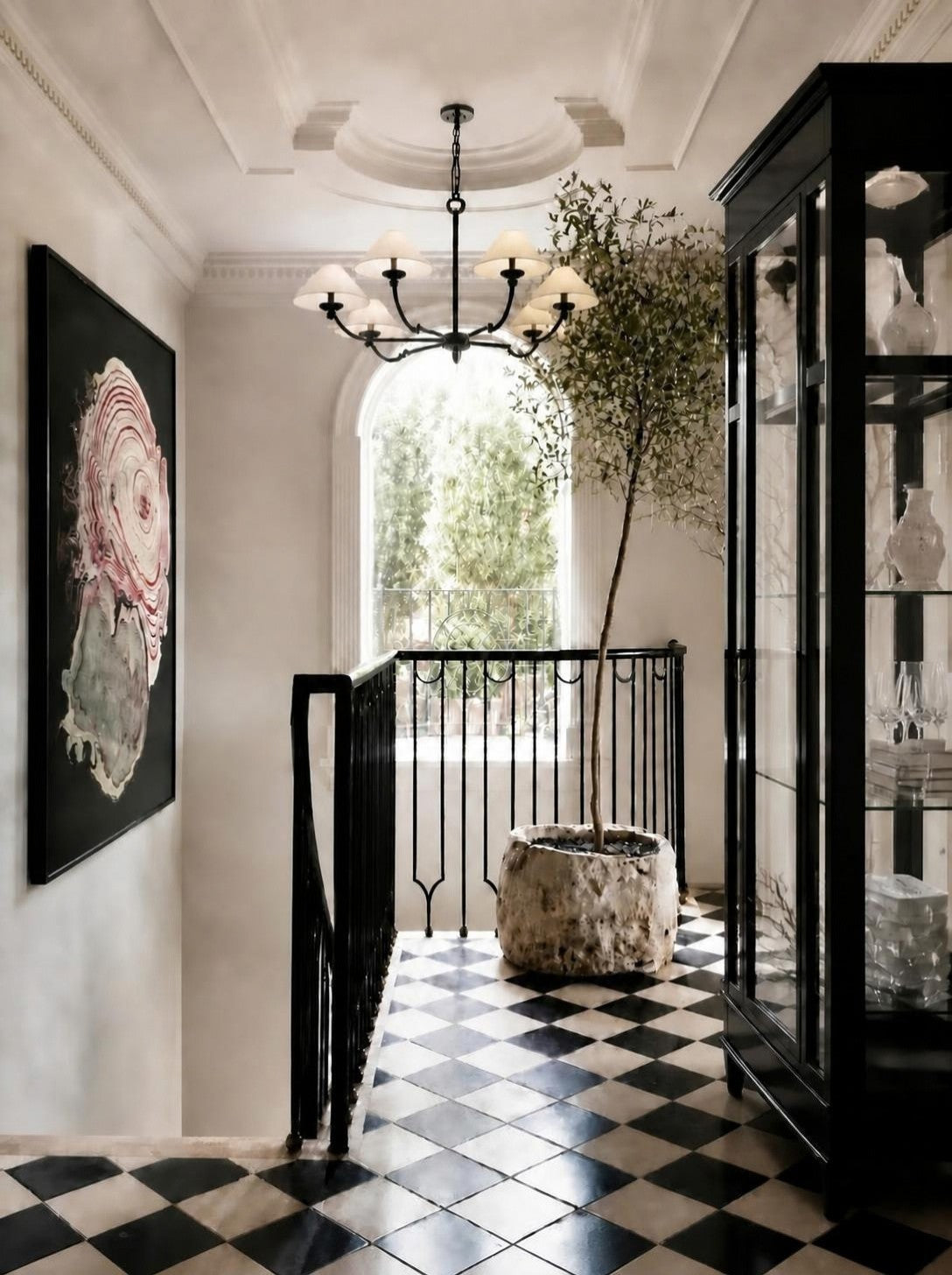 Classic Traditionalist entry designed by Rachel Blindauer: wrought iron chandelier, black lacquer display cabinet and marbled abstract art