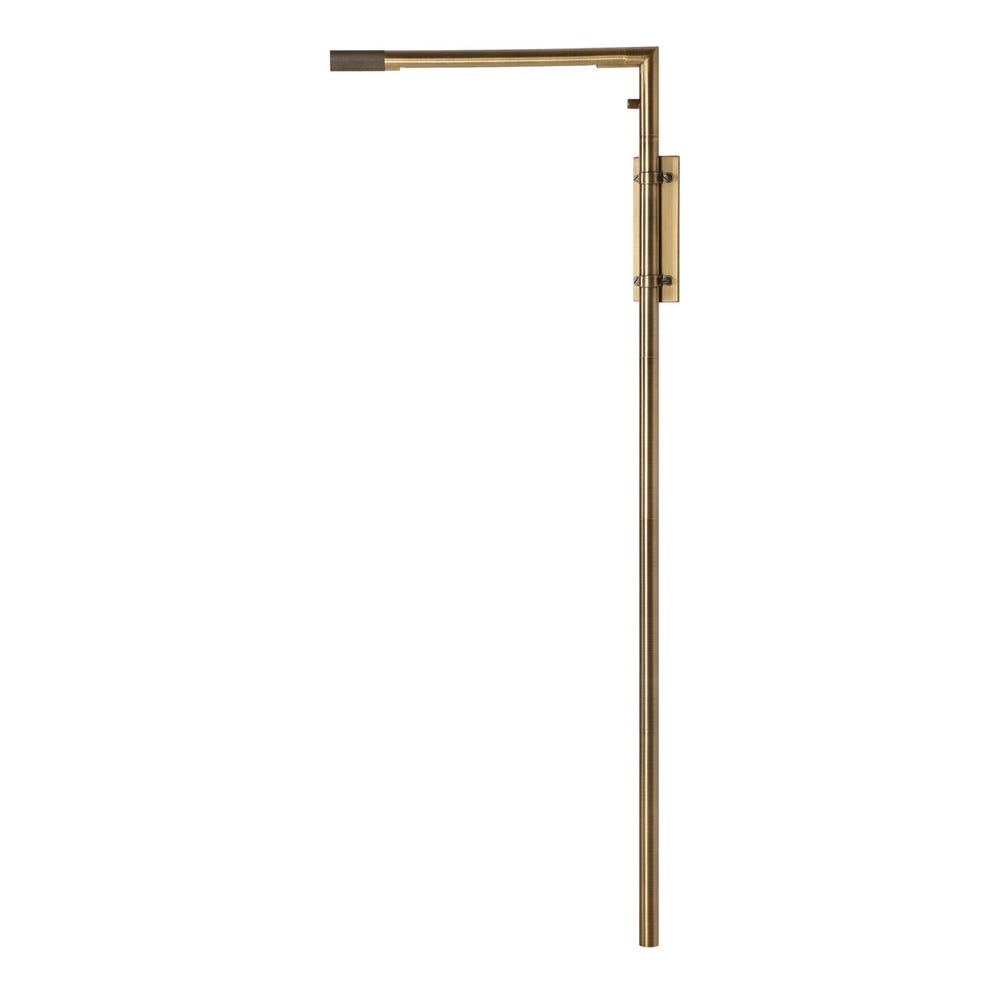 Antique brass wall sconce with adjustable rotating arm and integrated LED, styled in a minimalist reading nook for warm, directional lighting.
