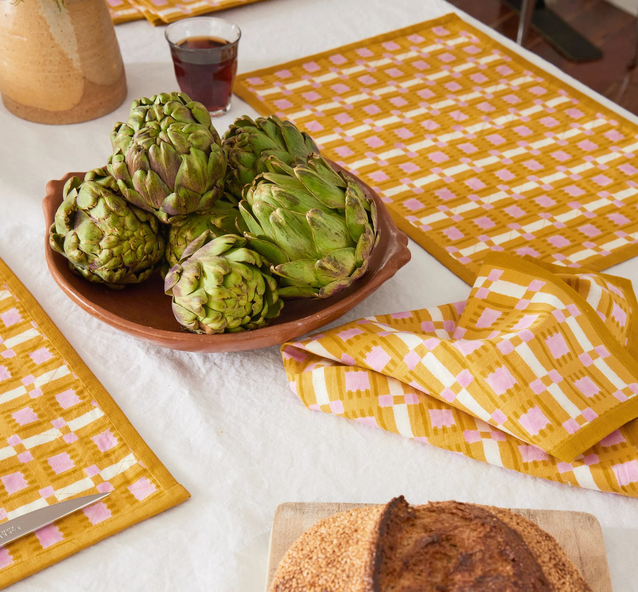 Hand block printed plaid napkin in terracotta, blush, and sand on linen-cotton blend
