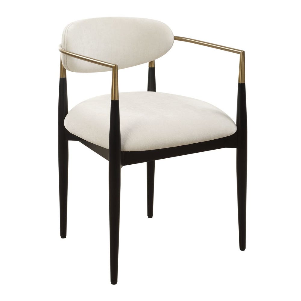 Mid-century modern dining armchair with off-white velvet upholstery, matte black wood legs, and brushed brass wraparound arms.