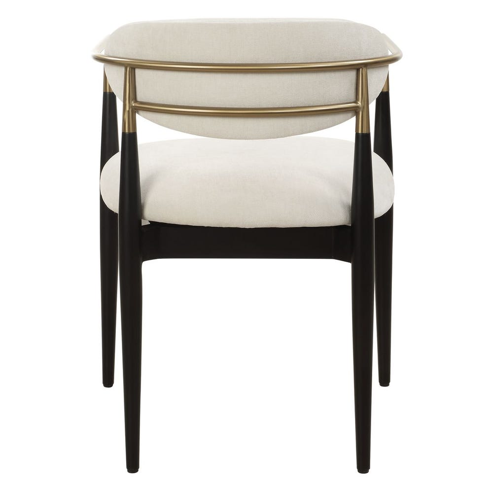 Mid-century modern dining armchair with off-white velvet upholstery, matte black wood legs, and brushed brass wraparound arms.