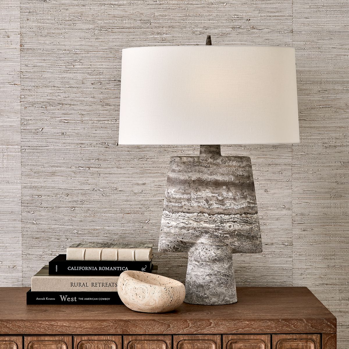 Hand-carved travertine bowls with organic curves and natural veining, designed as sculptural accents for coffee tables, consoles, or bookshelves.