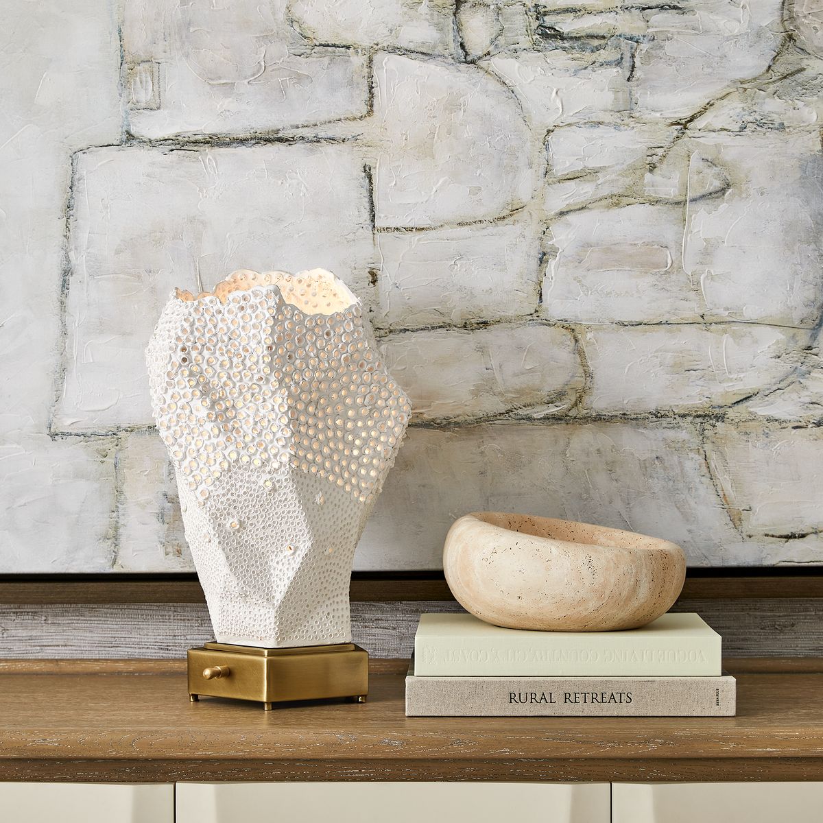 Hand-carved travertine bowls with organic curves and natural veining, designed as sculptural accents for coffee tables, consoles, or bookshelves.