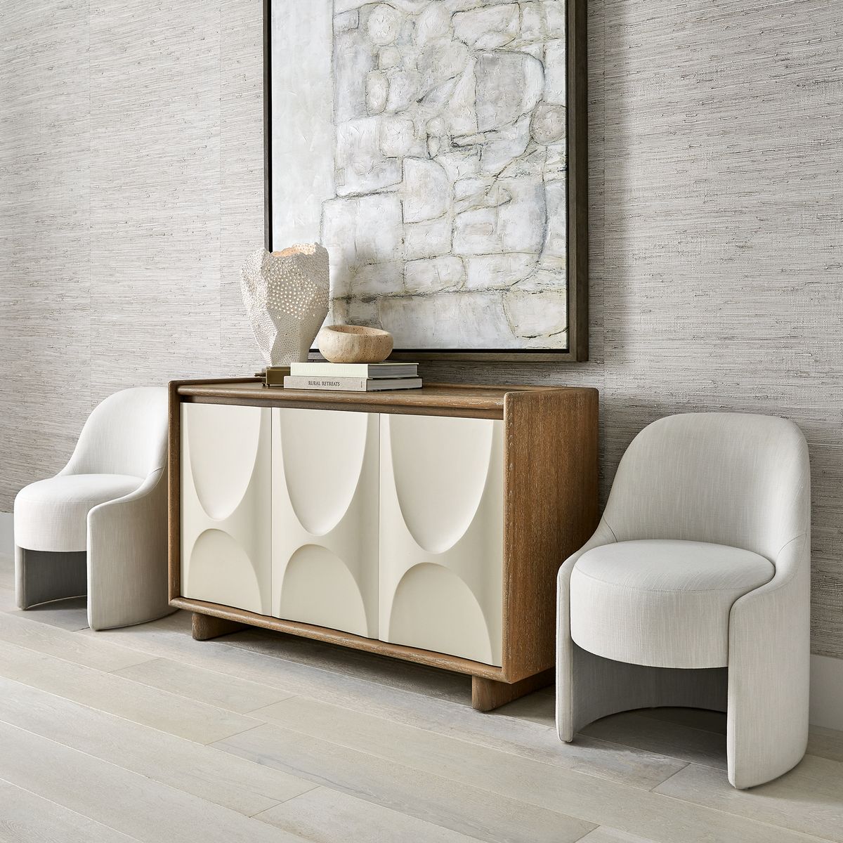 Hand-carved travertine bowls with organic curves and natural veining in room, designed as sculptural accents for coffee tables, consoles, or bookshelves.