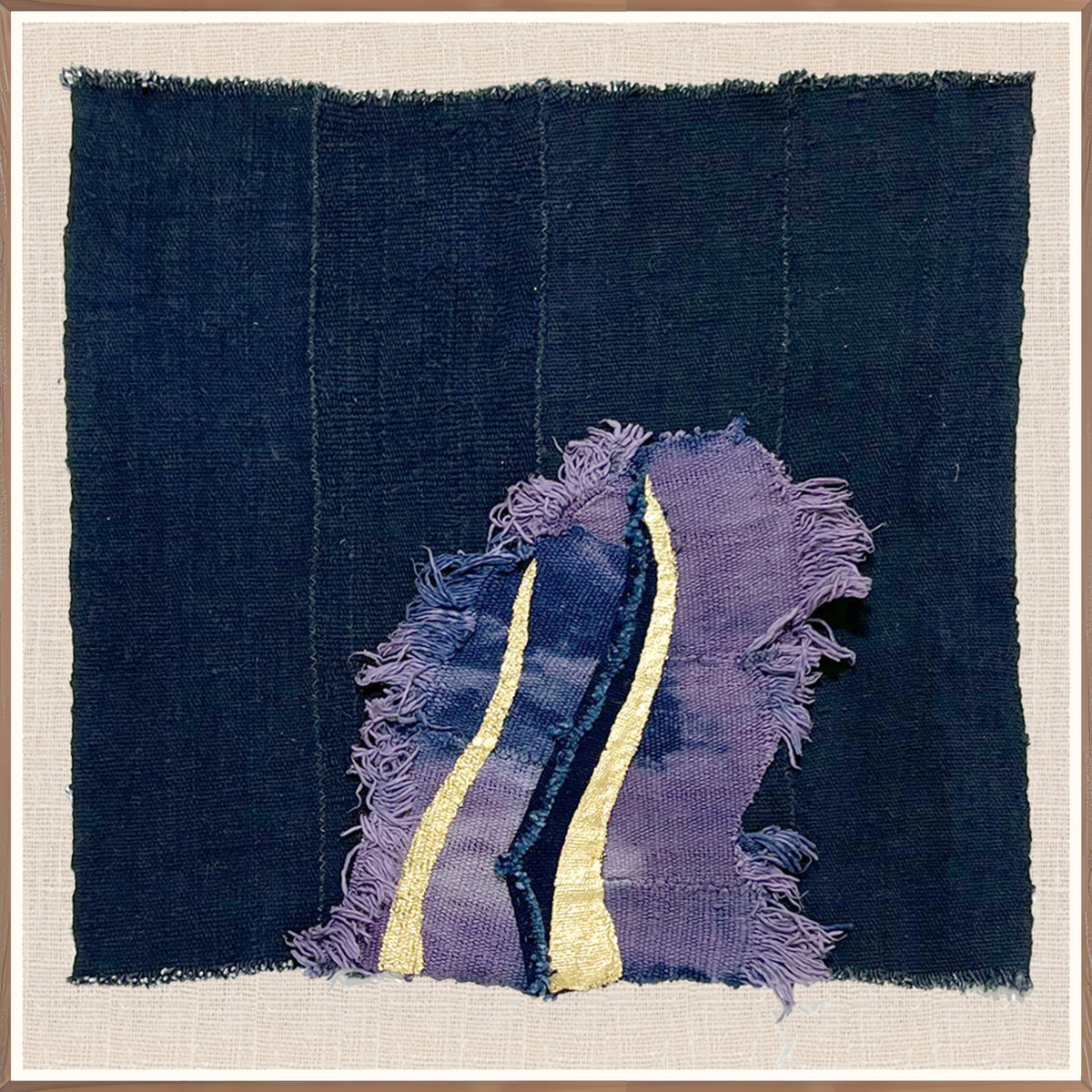 Small square hand-stitched textile artwork in indigo and gold