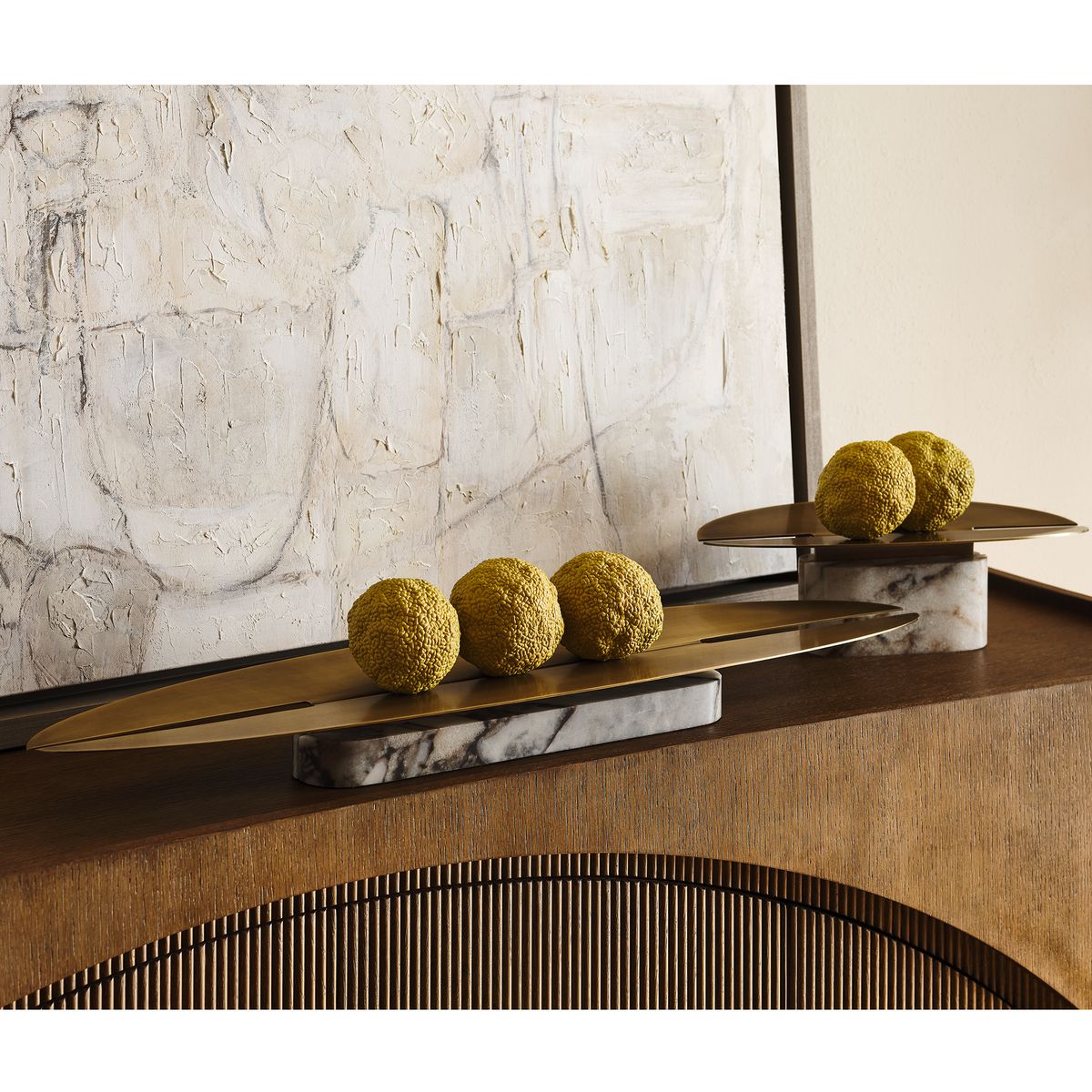 Linea Arc Vessel with matte brass top and honed marble base, styled as a sculptural centerpiece on a modern console.