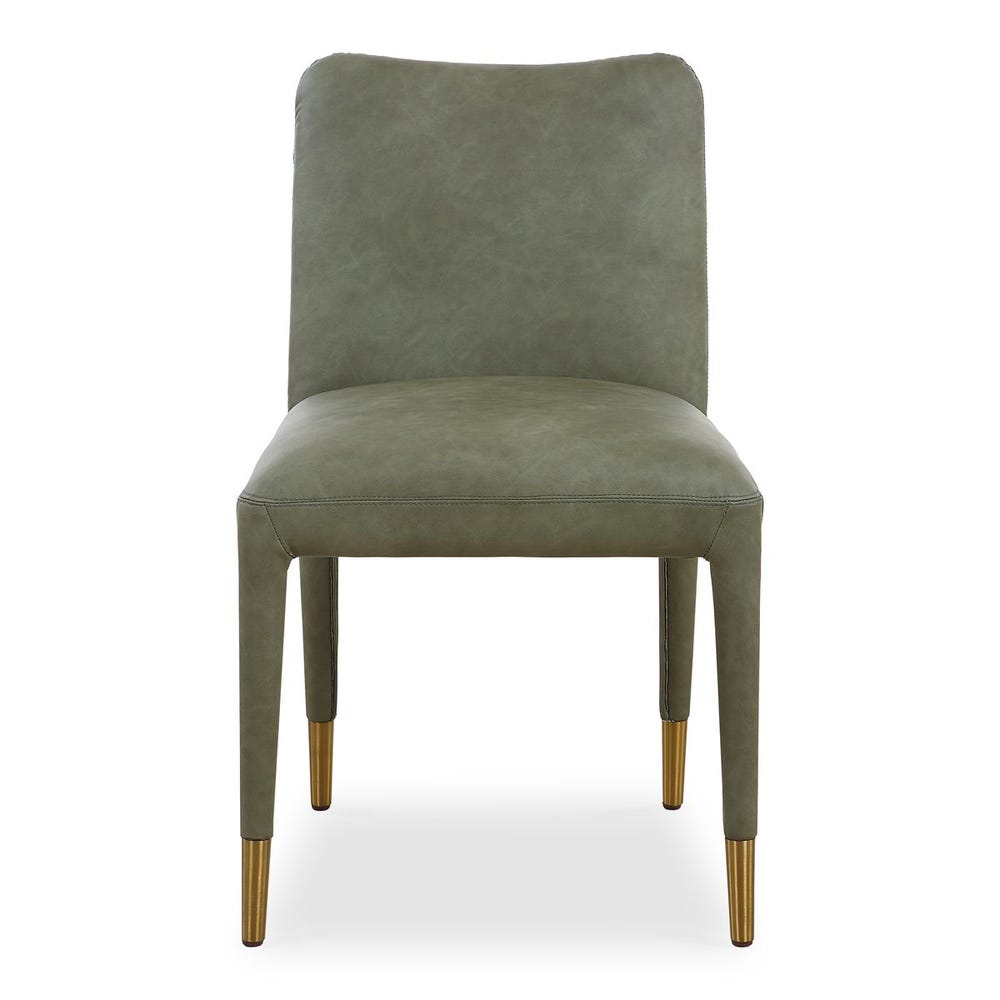 Armless tailored dining chair in emerald pine faux leather, featuring brushed brass ferrules and a sculptural silhouette.