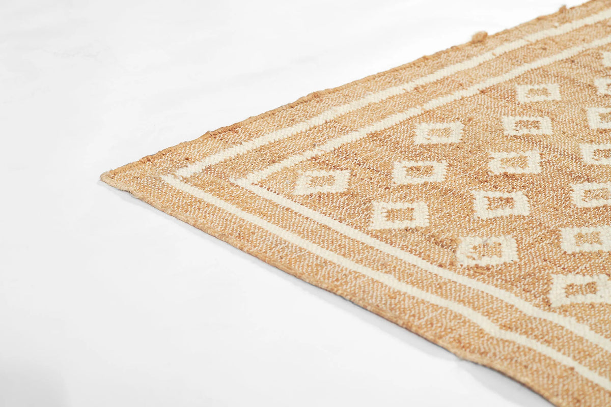 Marigold Handwoven Blockprint Flatweave Rug — angled view of corner showing diamond blockprint pattern and layered border detail, one of Rachel Blindauer's favorites
