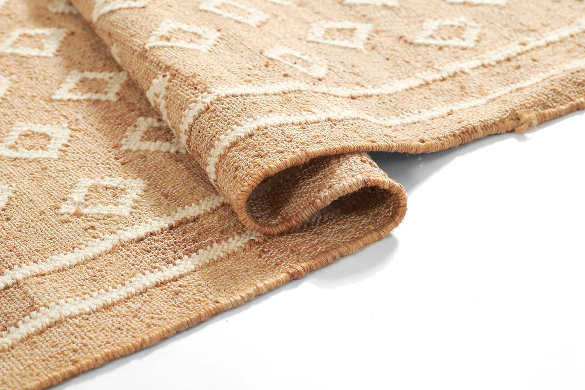 Marigold Handwoven Blockprint Flatweave Rug — rolled corner detail revealing jute backing and flatweave construction up close, one of Rachel Blindauer's favorites