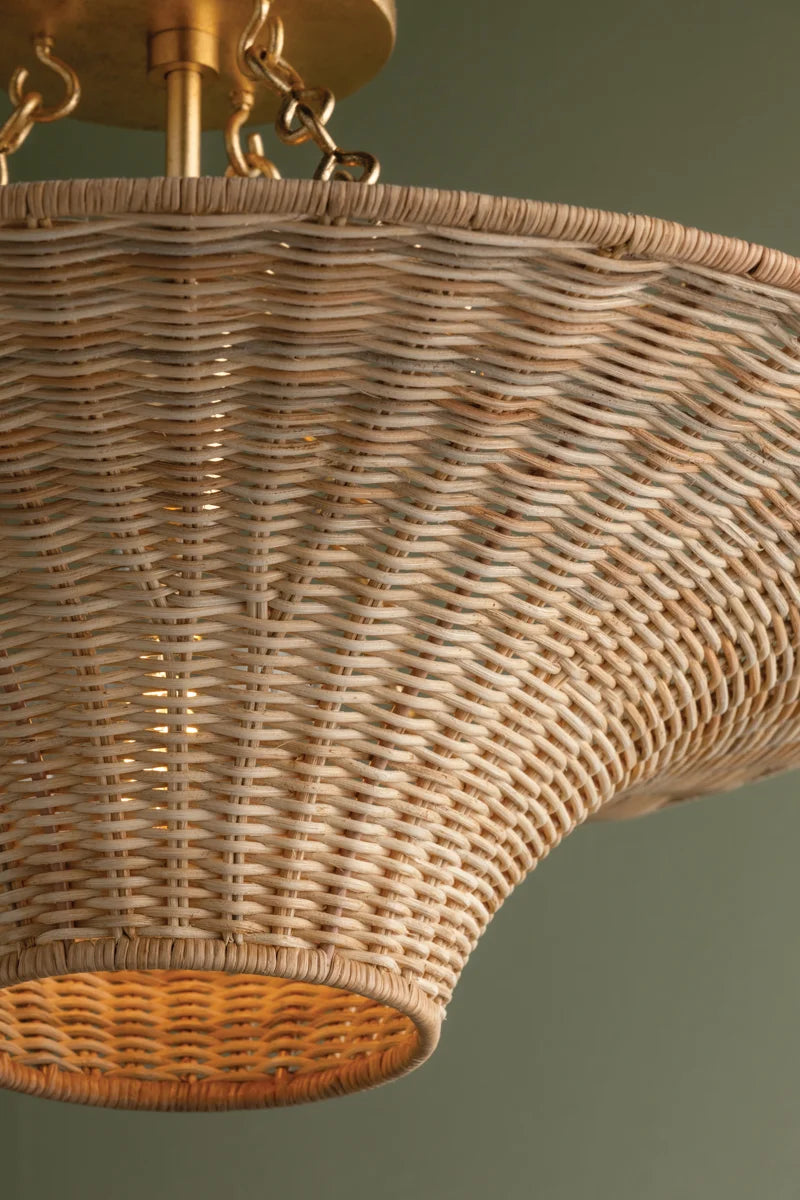 Handwoven wicker ceiling light with flared silhouette and gold canopy—coastal modern style with upward and downward ambient glow.