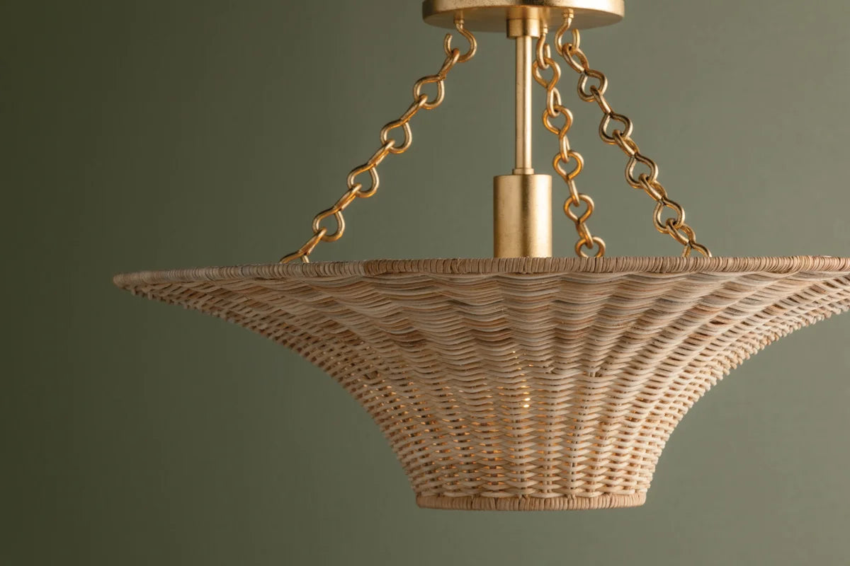 Handwoven wicker ceiling light with flared silhouette and gold canopy—coastal modern style with upward and downward ambient glow.