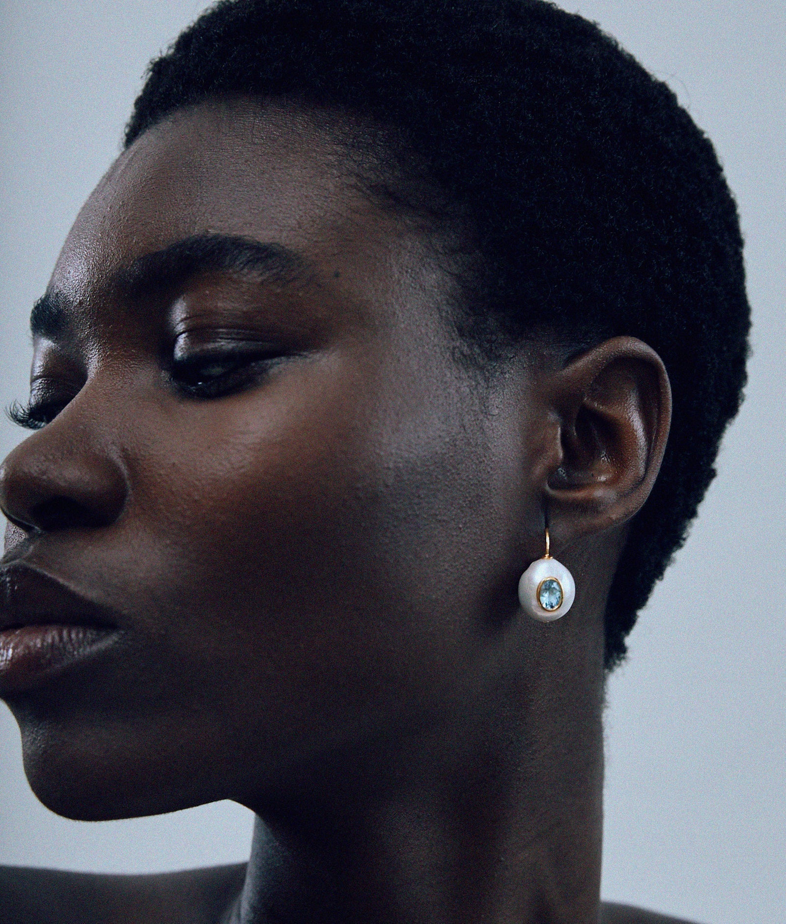 Gold-plated drop earrings with baroque freshwater pearls and faceted blue topaz accents