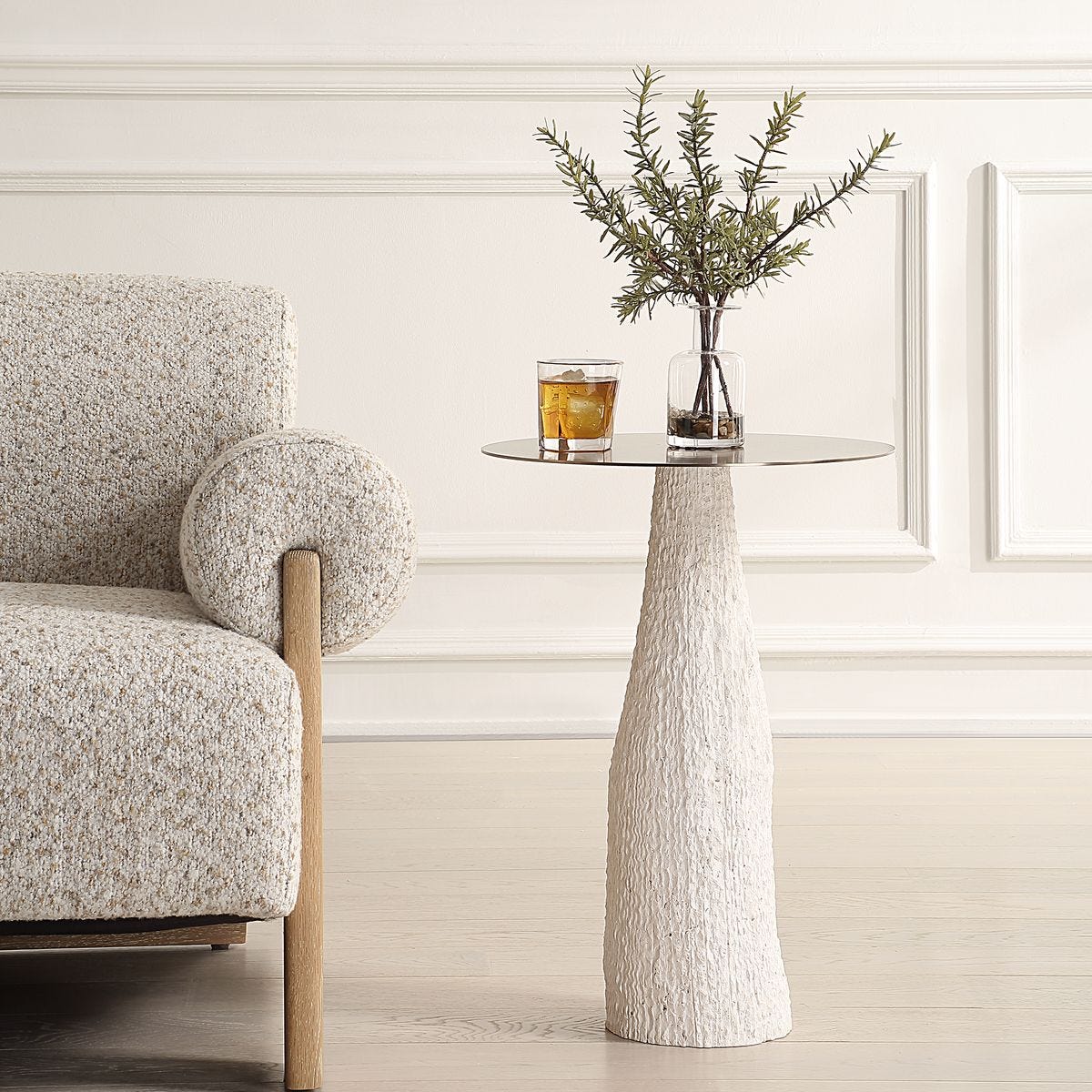 Architectural side table with textured cast stone base and brushed metal top, designed for quiet contrast and sculptural impact.