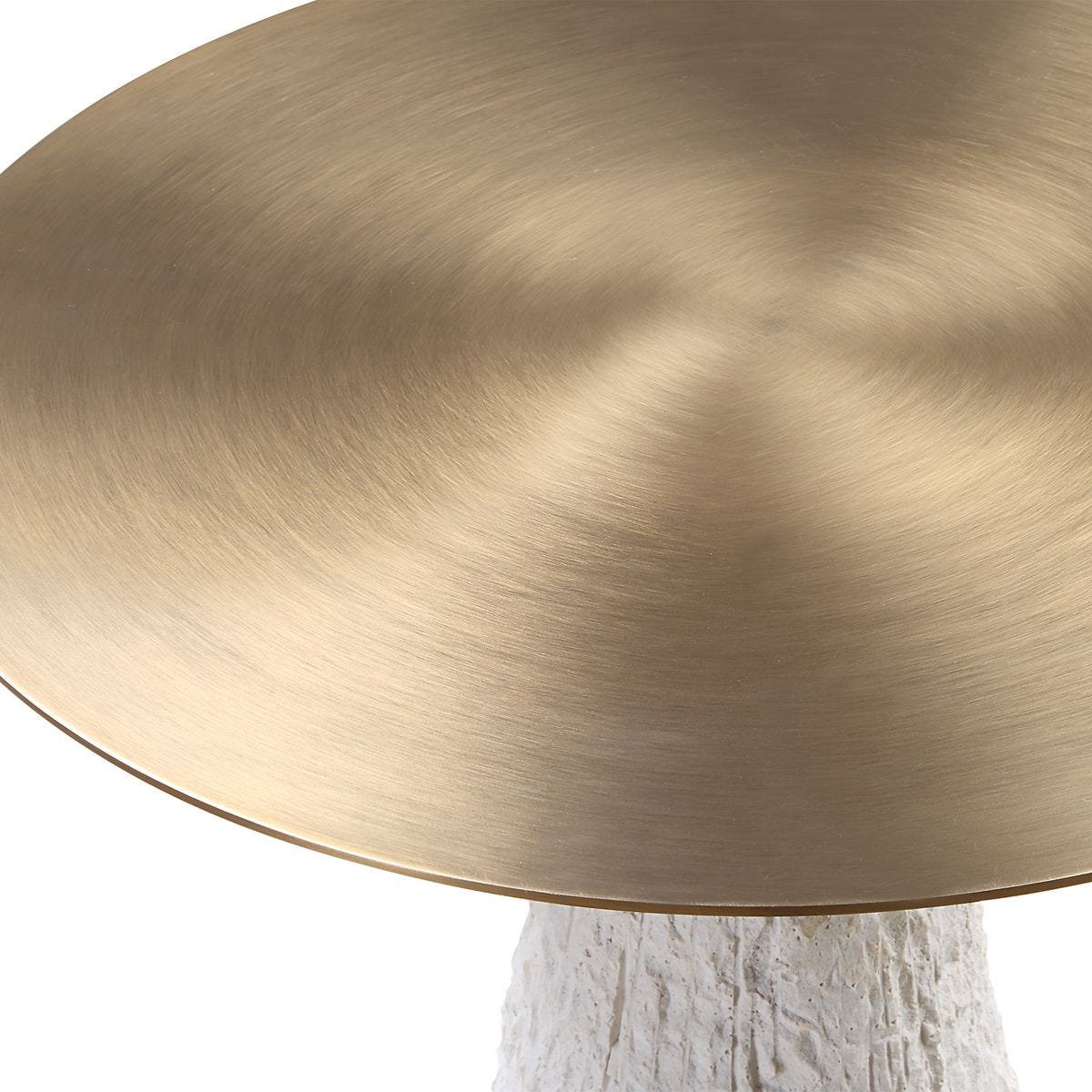 Detail of Architectural side table with textured cast stone base and brushed metal top